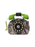A novelty clutch purse designed like a retro rotary telephone, featuring a green handset, a black dial with gold buttons, and a background print of US dollar bills, shown on a white background.